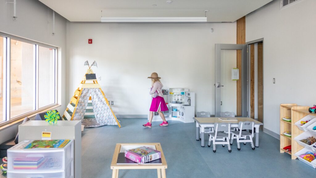 Photo of a child walking through a new classroom.